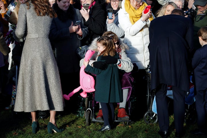 Charlotte gives a hug to a women in the crowd, who gifted her with a pink flamingo. 