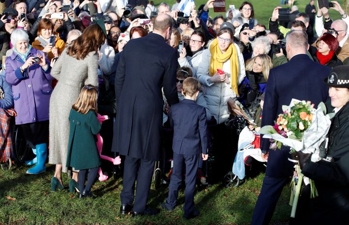 Prince William, Catherine, Duchess of Cambridge, Princess Charlotte and Prince George greet people as they leave the St Mary Magdalene's church after the Royal Family's Christmas Day service on Dec. 25, 2019.