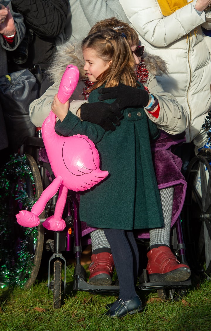 Gemma Clark from Lincolnshire hugs Charlotte after the Christmas Day morning church service at St Mary Magdalene Church in Sa