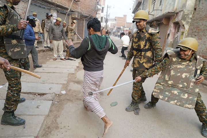 Police in Varanasi, Uttar Pradesh beat a man during protests against the CAA on December 20, 2019. 