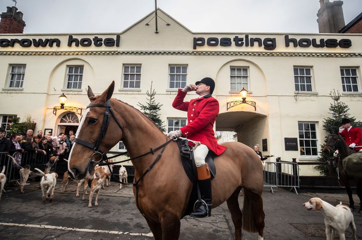 A huntsman drinks a shot of whisky outside the Crown Hotel in Bawtry, ahead of the Grove and Rufford Hunt.