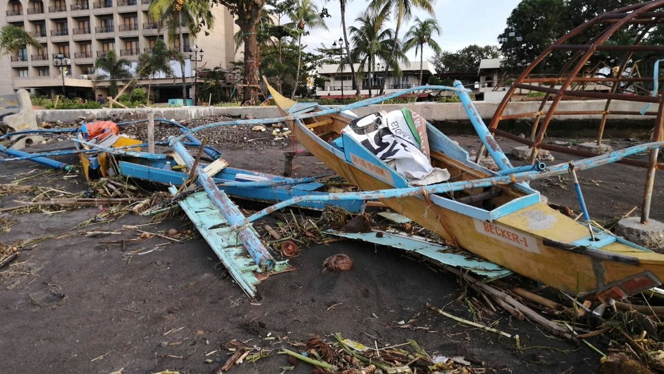 An outrigger boat destroyed by the storm in Ormoc City, central Philippines. The typhoon left over a dozen dead and many home