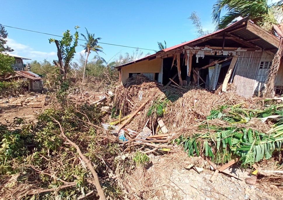 Debris from floods caused by Typhoon Phanfone surround a damaged house in Balasan Town, Iloilo province, central Philippines.