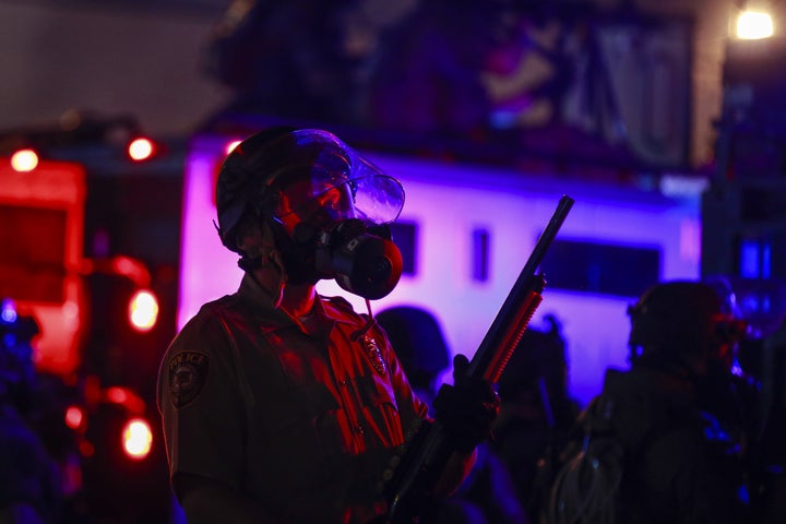 Police forces stand at the ready in Ferguson, Missouri, as protesters take the streets to protest the killing of Michael Brown in 2014, shortly after Missouri Gov. Jay Nixon declared a curfew and a state of emergency.