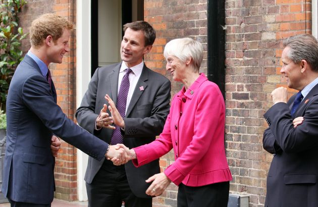 Britain's Prince Harry shakes hands with Susan Catherine Campbell in 2012.