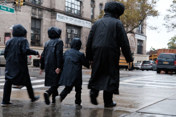 Members of the Jewish community walk through a Brooklyn neighborhood on Oct. 9, 2019, in New York City.