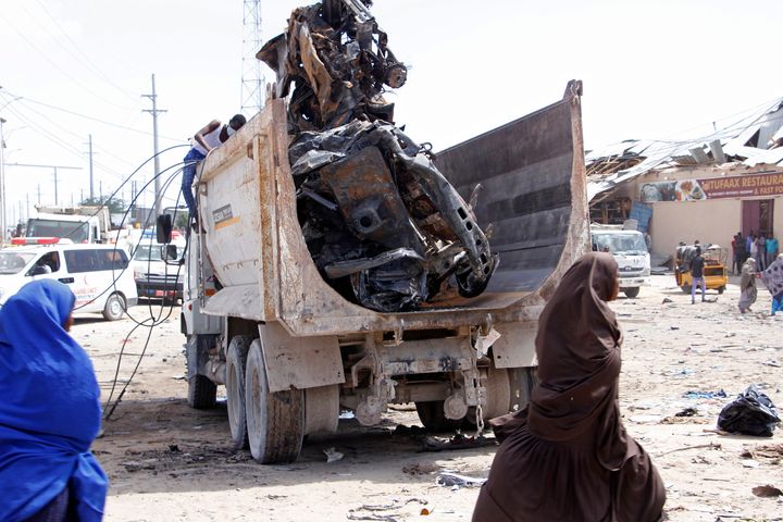 A truck carries wreckage of a car used in a car bomb in Mogadishu, Somalia, Saturday, Dec. 28, 2019. 