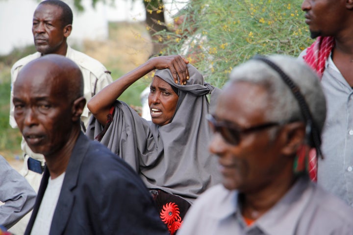 A mother waits outside hospital to hear news of her son after a car bomb in Mogadishu, Somalia, Saturday, Dec. 28, 2019.