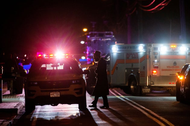 A Jewish man walks near the area where 5 people were stabbed at a Hasidic rabbi's home in Monsey, New York.