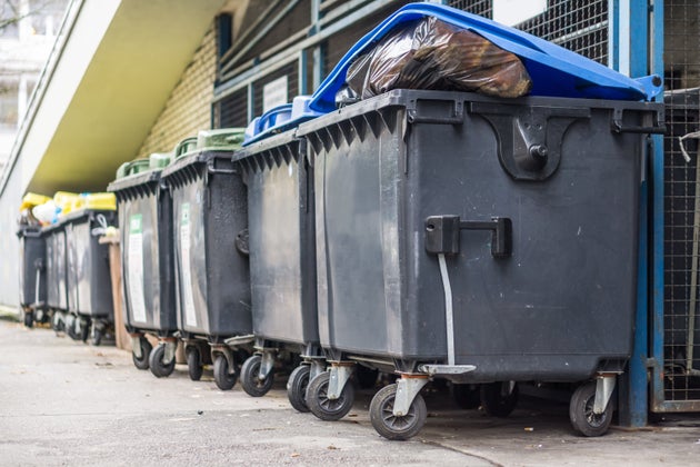 Overflowing garbage bins with household waste in the