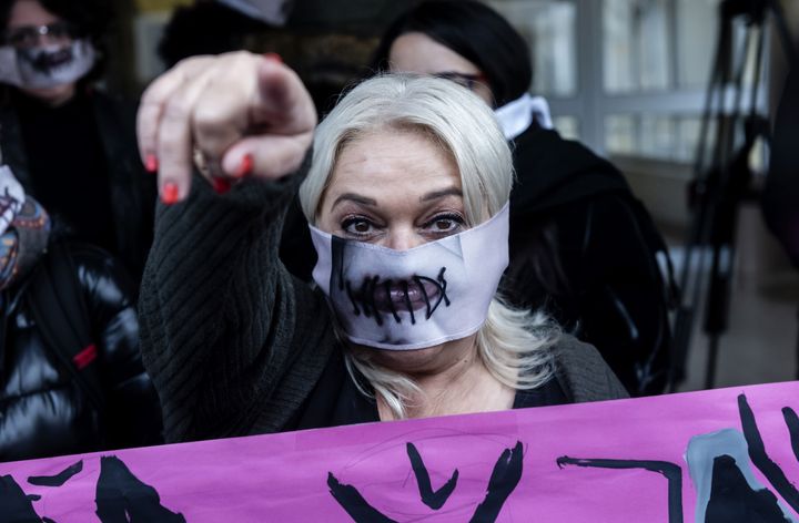 A women's rights activist participates in a protest in support of a British teenager outside Famagusta District Court in Paralimni.