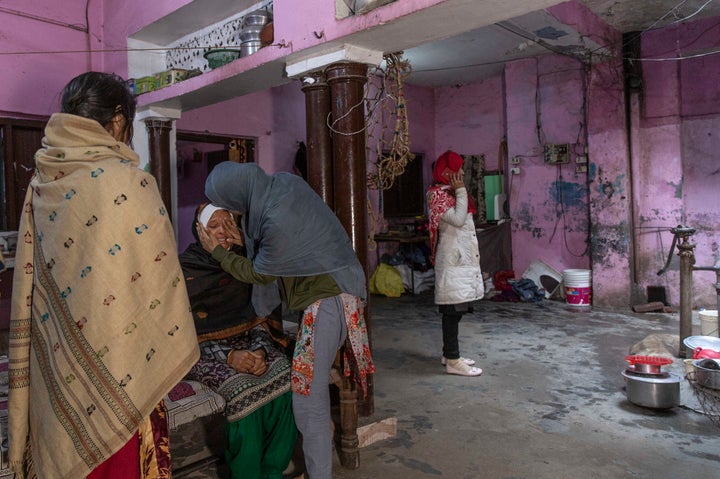 The relatives of Suleman, a victim of police violence, console his grieving mother.