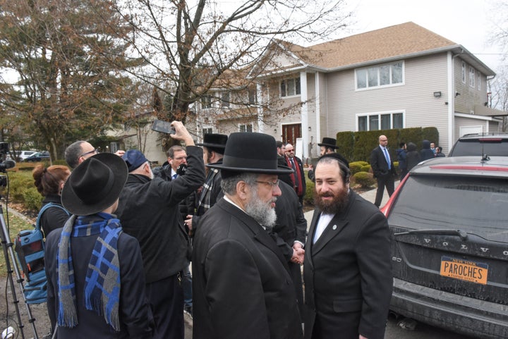 Members of Rabbi Chaim Rottenberg's community gather in front of the house of Rabbi Chaim Rottenberg on December 29, 2019 in