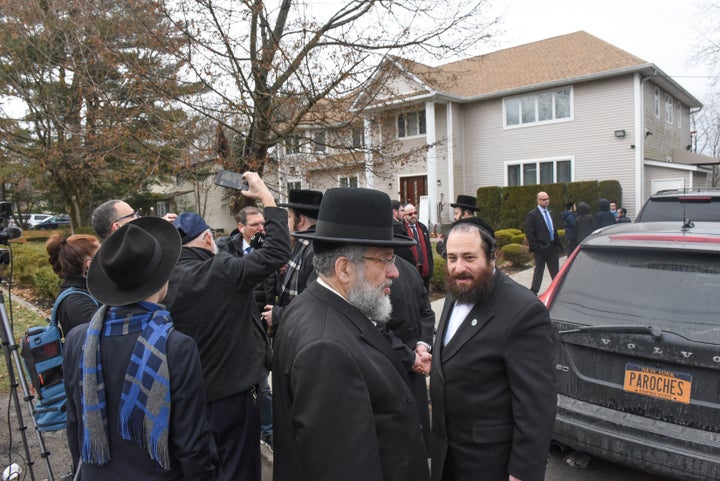 Members of Rabbi Chaim Rottenberg's community gather in front of the house of Rabbi Chaim Rottenberg on December 29, 2019 in Monsey, New York. 