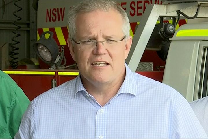 In this image made from video, Australia's Prime Minister Scott Morrison speaks to firefighters in Mudgee, New South Wales Monday, Dec. 23, 2019. Morrison on Monday praised emergency service workers for their efforts to combat fires which raged throughout New South Wales. (Australian Pool via AP)