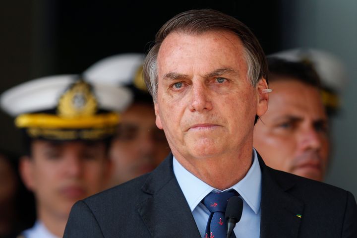 With a bandage on his ear, Brazil's President Jair Bolsonaro attends a military ceremony in honor of Sailor Day in Brasilia, Brazil, on Dec. 13, 2019. Bolsonaro said to the press on Dec. 11 that he has a possible skin cancer after he had a mole removed from his ear.