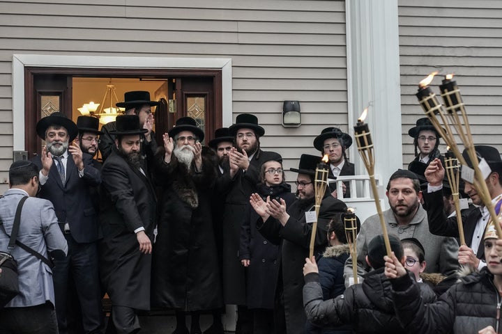 Rabbi Chaim Rottenberg (center left with white beard) celebrates the arrival of a new Torah at his residence in Monsey, New York, on Dec. 29, 2019.