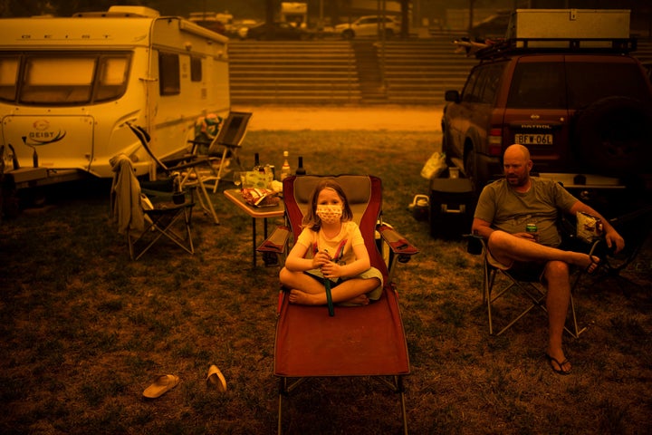 Amy and Ben Spencer sit at the showgrounds in the southern New South Wales town of Bega where they are camping after being evacuated from nearby sites on Dec. 31, 2019.