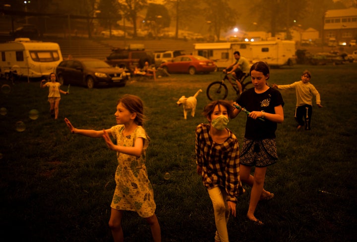 Children play at the showgrounds in the town of Bega where they are camping the fires forced them from their homes. 