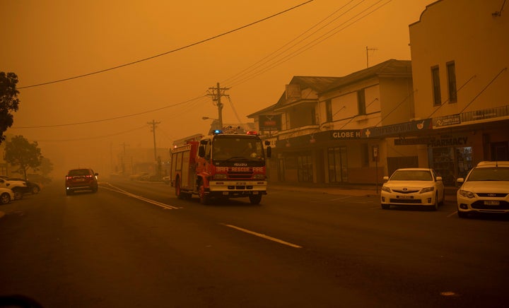 A fire truck moves up the main street of the New South Wales town of Bombala which is shrouded in smoke on Dec. 31, 2019.