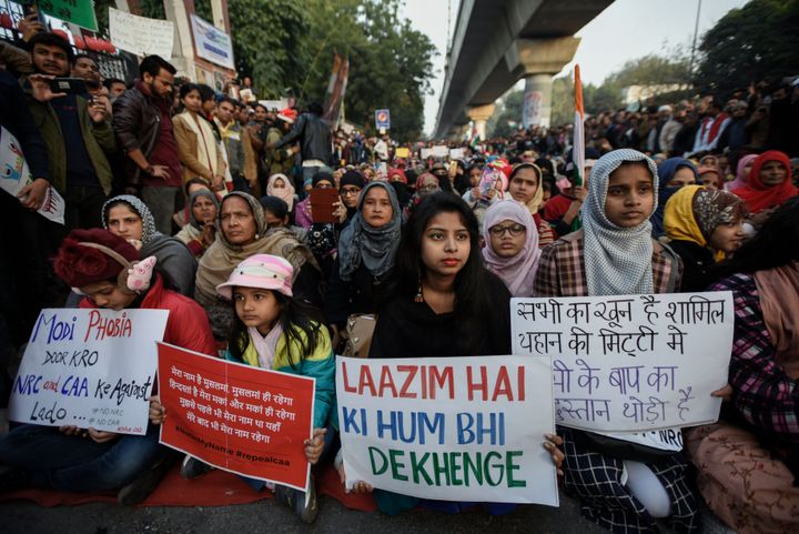 NEW DELHI, INDIA - DECEMBER 25: People hold placards as they take part in a protest on the 11th straight day, against the Citizenship Amendment Act (CAA) and National Register of Citizens (NRC) at Jamia Millia Islamia on December 25, 2019 in New Delhi, India. (Photo by Burhaan Kinu/Hindustan Times via Getty Images)