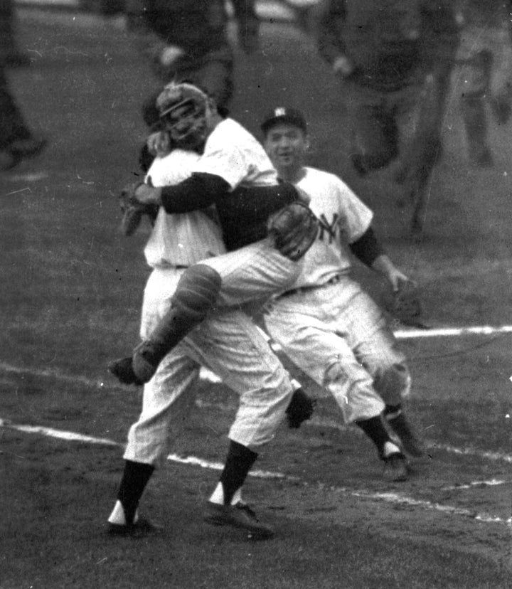 In this 1956 file photo, New York Yankees catcher Yogi Berra leaps into Don Larsen's arms at the end of Game 5 of baseball's 