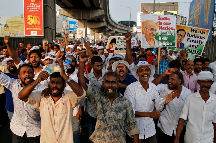 Demonstrators shout slogans as they attend the protest rally.