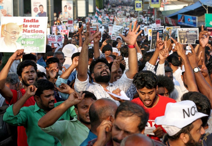 Demonstrators shout slogans as they attend the protest rally in Kochi.