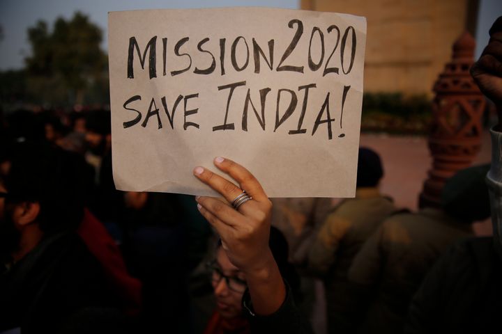 A student holds a placard during a protest against CAA in front of India Gate war memorial, in New Delhi, Jan. 1, 2020. 