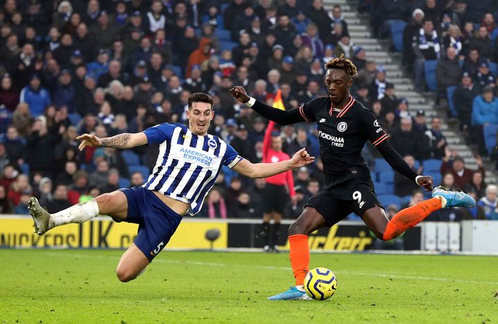 Chelsea's Tammy Abraham, right, and Brighton's Lewis Dunk battle for the ball during a New Year's Day match between Brighton and Chelsea at the Amex Stadium in Brighton