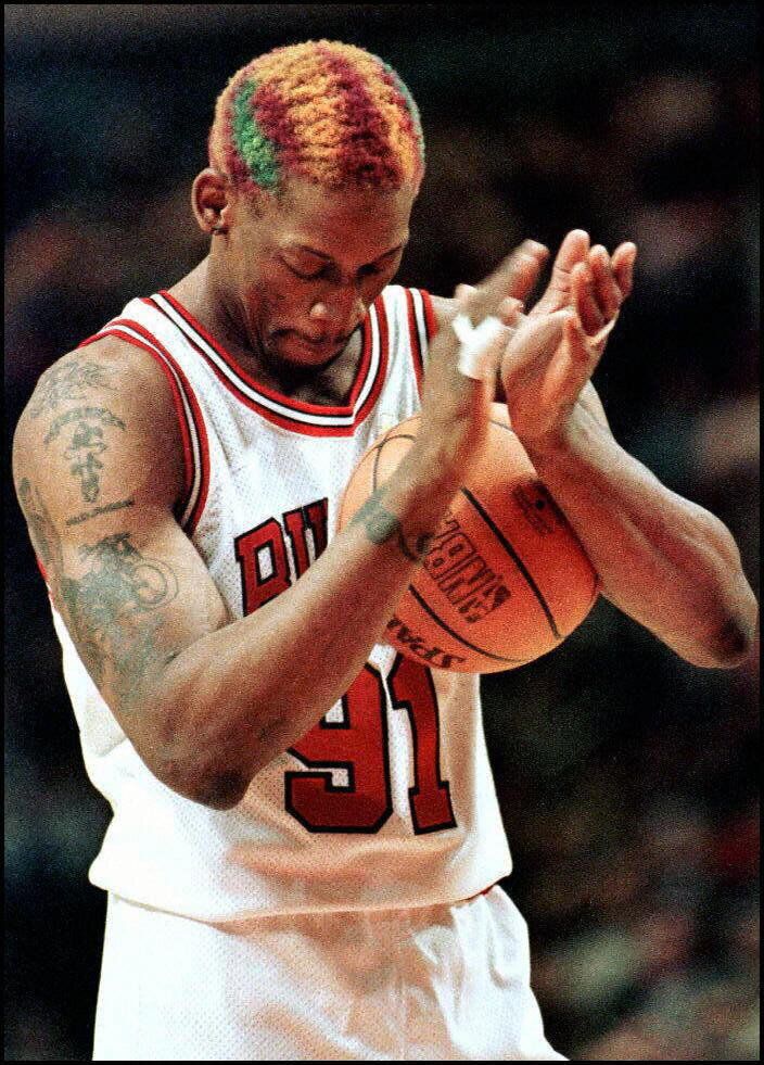 Chicago Bulls forward Dennis Rodman claps after making a free throw that sealed a victory against the Los Angeles Lakers in the last seconds of overtime on Dec. 17, 1996.
