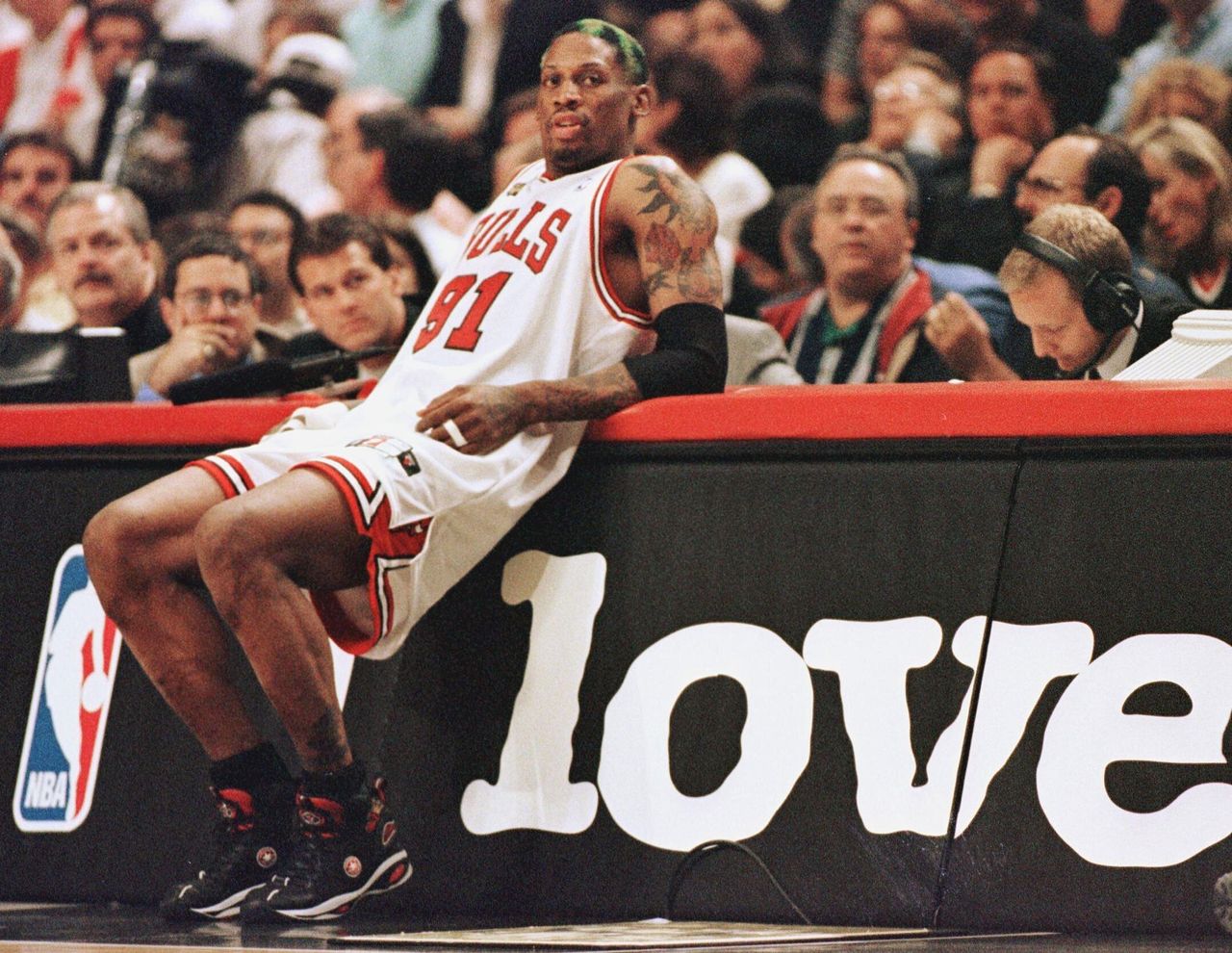 Rodman leans on the scorers' table as he waits to come into the game against the Utah Jazz in game four of the NBA Finals on June 10, 1998.