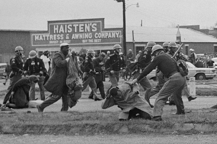 State troopers breaking up a voting rights march in Selma, Alabama, on March 7, 1965. In the foreground, John Lewis, then chairman of the Student Nonviolent Coordinating Committee and a future U.S. congressman, is being beaten by a state trooper, who fractured Lewis' skull.