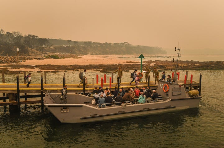 MALLACOOTA, AUSTRALIA - JANUARY 02: (AUSTRALIA OUT): People stranded in Mallacoota, Victoria are evacuated by army personnel to the HMAS Choules after bushfires ravaged the town on December 30th on January 3, 2020 in Mallacoota, Victoria, Australia. (Photo by Justin McManus/The Age/Fairfax Media via Getty Images)