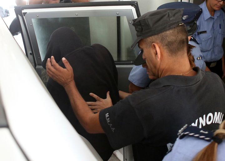 The 19-year old British woman, centre, with head covered, being escorted to Famagusta court in Paralimni, Cyprus