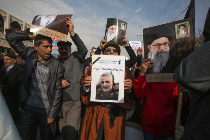 Iranians holds posters of Iran's supreme leader Ayatollah Ali Khamenei and Soleimani during a demonstration in Tehran.