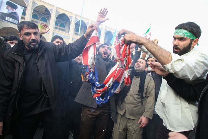 Iranians burn an American flag.