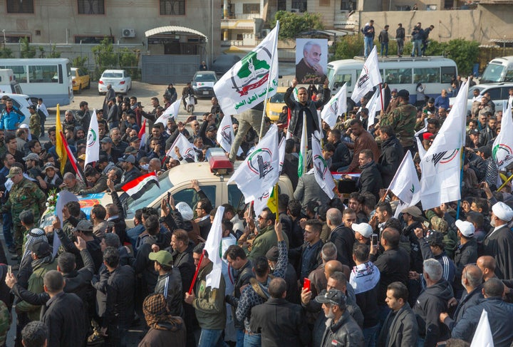 Mourners march during the funeral of Iran's top general Qassem Soleimani, 62.