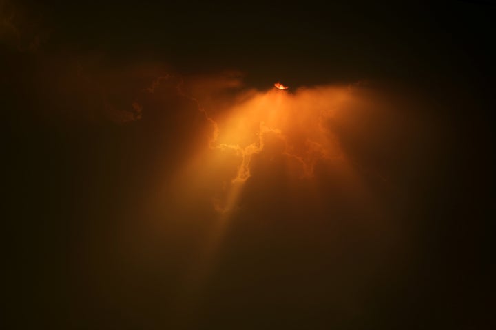 The sun struggles through the clouds as high winds push smoke and ash from the Currowan Fire towards Nowra, New South Wales, Australia January 4, 2020. qhiukiuiqkqinv