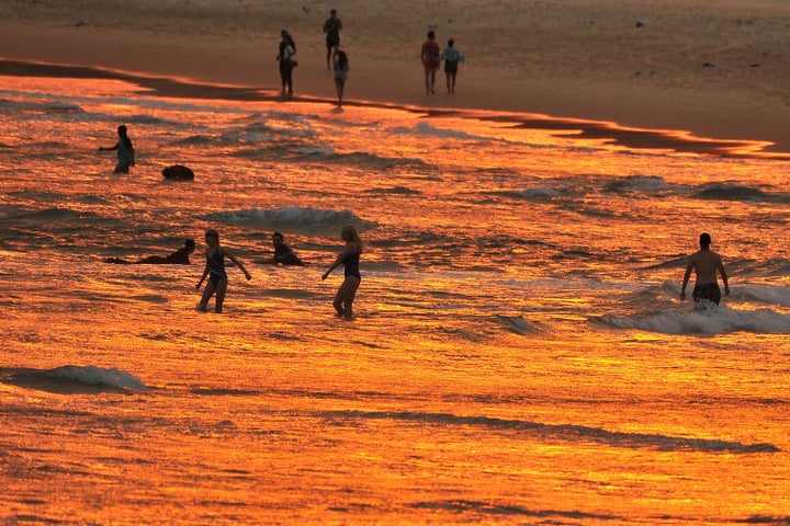 Beachgoers enjoy the sunset at Bondi beach during a heatwave in Sydney on Dec. 19. A state of emergency was declared in Australia's most populated region that day as an unprecedented heatwave fanned out-of-control bushfires, destroying homes and smothering huge areas with toxic smoke.