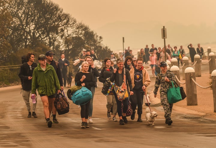 People stranded in Mallacoota, Victoria, are evacuated in the first days of January by army personnel to the HMAS Choules after bushfires ravaged the town.