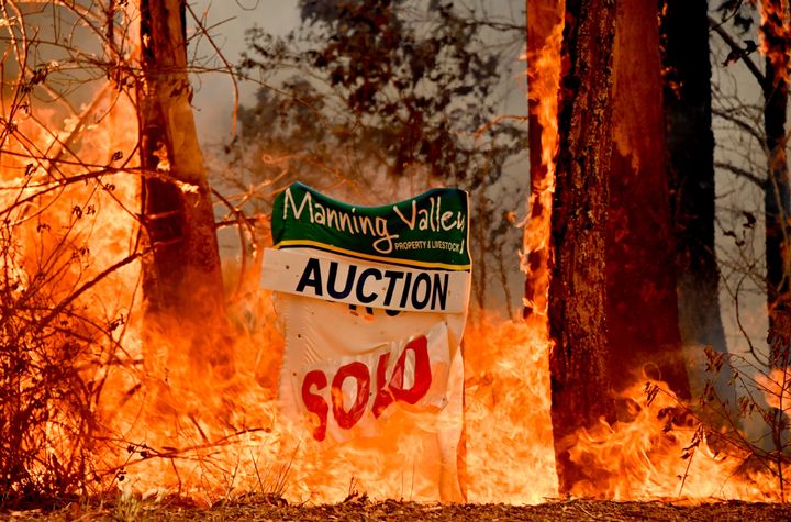 A bushfire burns outside a property near Taree, 350 km north of Sydney, on Nov. 12.
