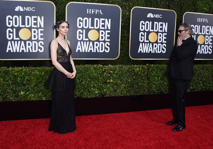 Rooney Mara, left, walks on the red carpet as Joaquin Phoenix looks on at the 77th annual Golden Globe Awards at the Beverly Hilton Hotel on Sunday, Jan. 5, 2020, in Beverly Hills, California.