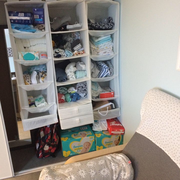 Some hanging shelves transformed my side of the closet into storage for all the crap a baby needs.