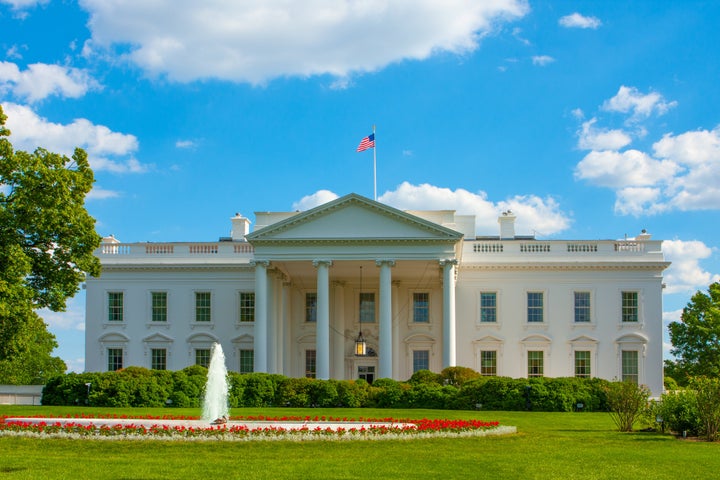 White House on a bright summer day with fluttering US flag