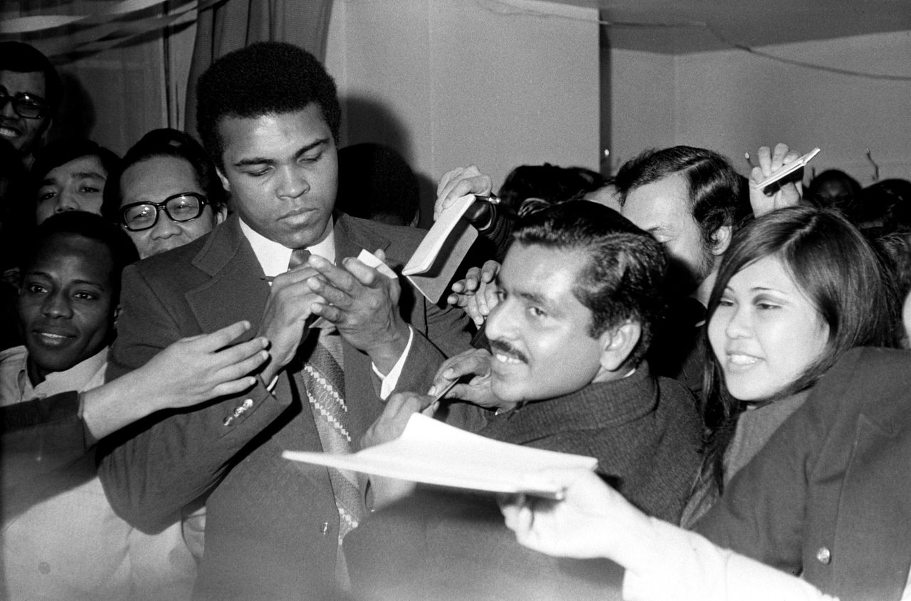 The future Muhammad Ali signs autographs for adoring fans two days before his Feb. 10, 1962, bout with Sonny Banks in New York.