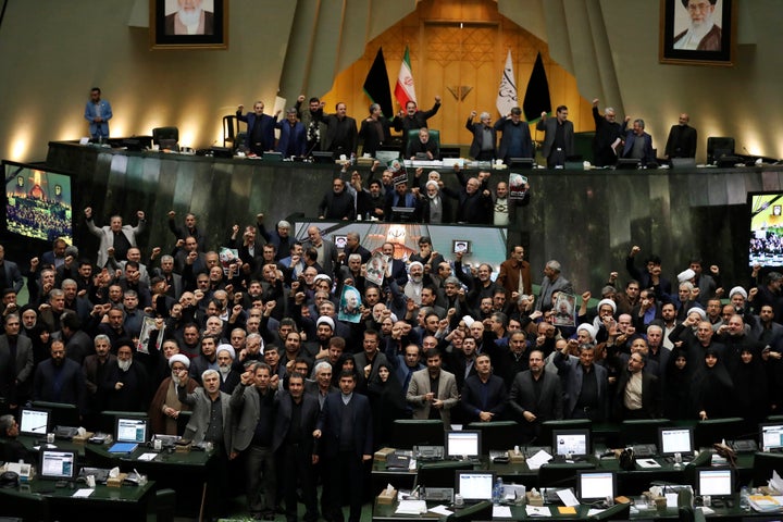 Iranian lawmakers chant slogans as some of them hold posters of Gen. Qassem Soleimani, who was killed in Iraq in a U.S. drone