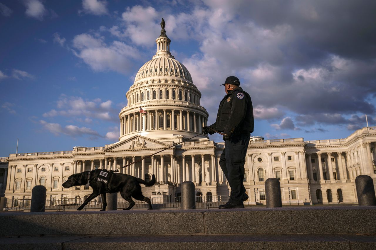A police officer and K-9 do a security sweep early on Monday as Congress returns to to Washington to face the challenge of fallout from President Donald Trump's military strike in Iraq.