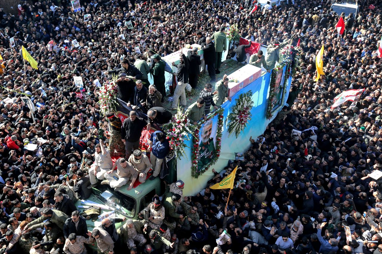 Coffins of Gen. Qassem Soleimani and others who were killed in Iraq by a US drone strike, are carried on a truck surrounded by mourners during a funeral procession, in the city of Kerman, Iran, Tuesday.