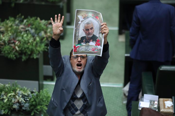 Iranian MP holds a poster of Gen. Qassem Soleiman in the Tehran parliament